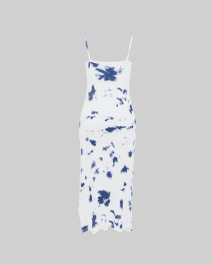 White dress with blue tie-dye pattern on a gray background