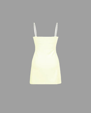 Light yellow dress with thin straps on a gray background