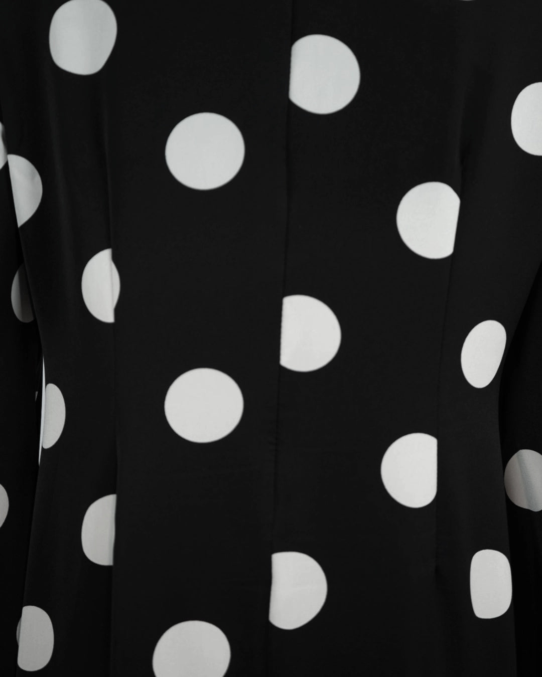 BeboNLolo black polka dot dress close-up showing neckline tie detail and fabric texture – Close-Up View