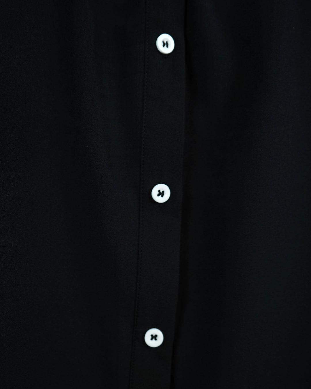 BeboNLolo Ruffle Charm Button Top in black close-up showing button details and ruffle sleeve trim – Close-Up View