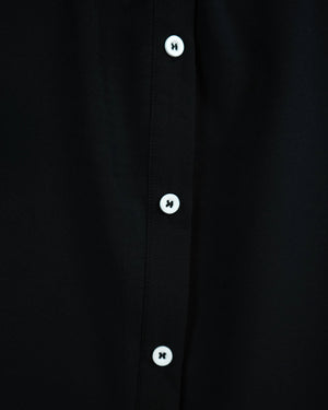 BeboNLolo Ruffle Charm Button Top in black close-up showing button details and ruffle sleeve trim – Close-Up View