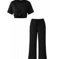 Black polka dot top and pants set on a white background