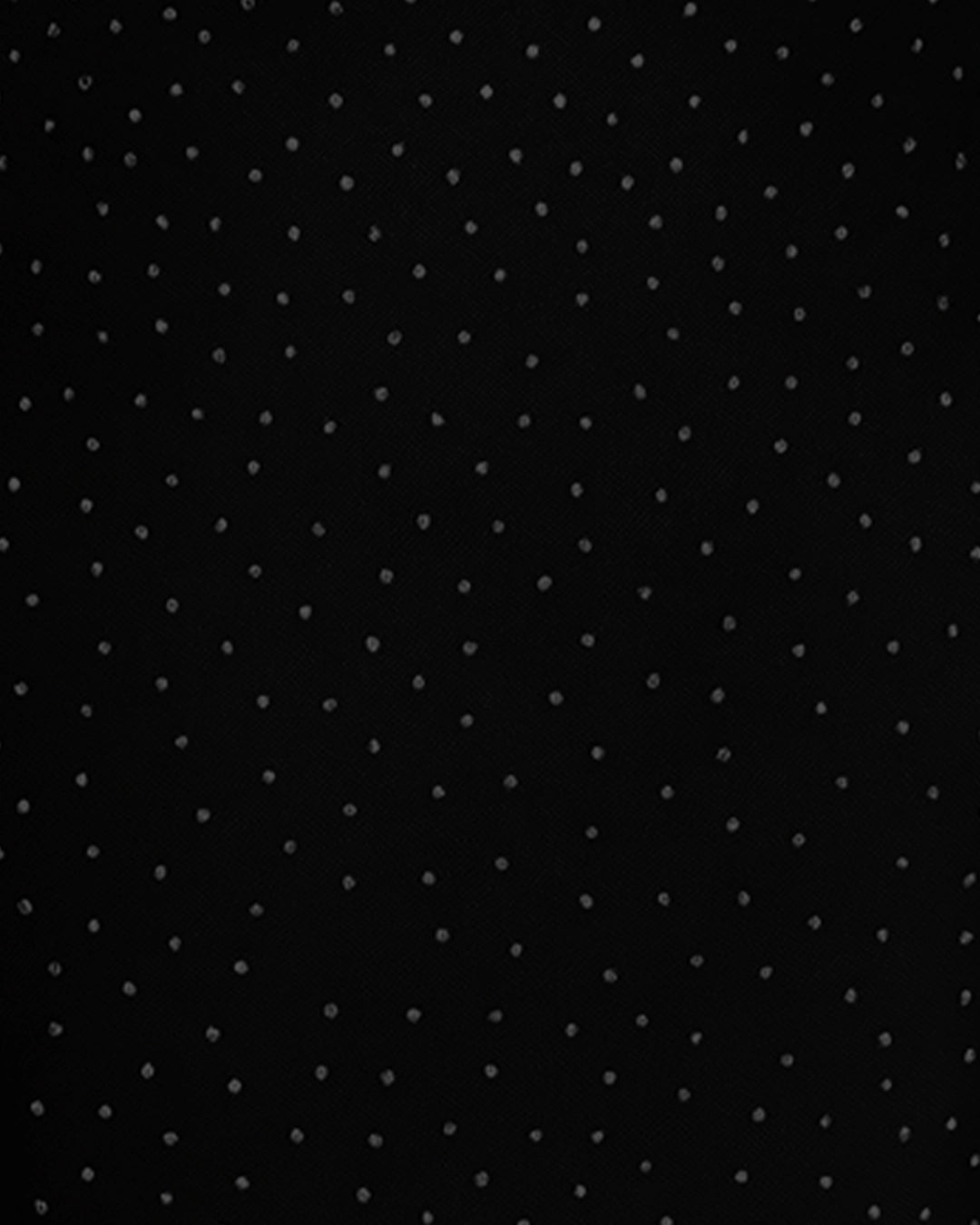 Black fabric with small white polka dots