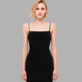 Woman wearing a black dress against a gray background