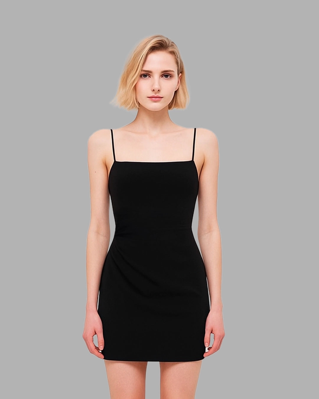 Woman wearing a black dress against a gray background