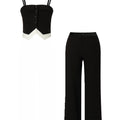 Black strapless top and black pants on a white background