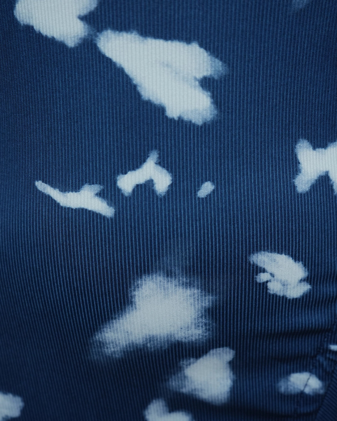 Close-up of a dark fabric with light blue floral patterns