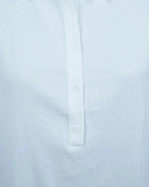 Close-up of a light blue shirt with button details on a white background