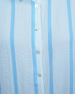 Close-up of a light blue and white striped shirt with buttons.