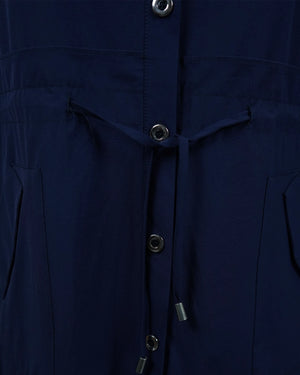 Close-up of a navy blue jacket with buttons and drawstrings.