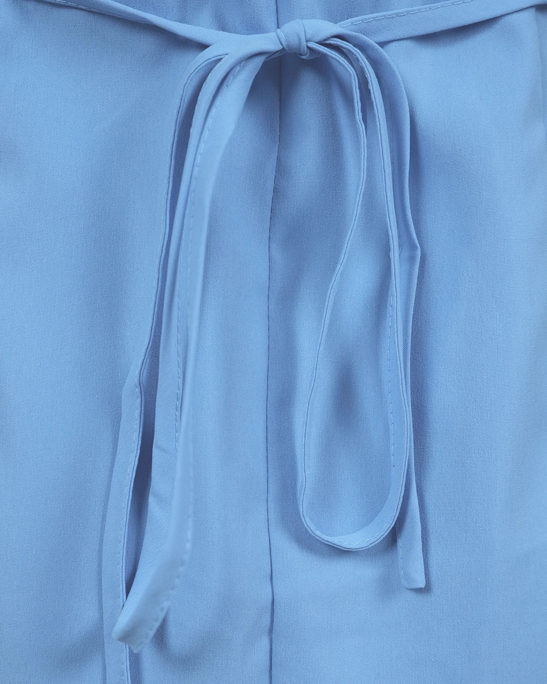 Close-up of a light blue garment with a tie detail