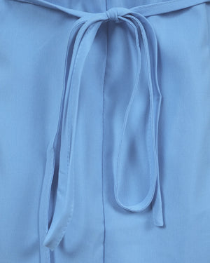Close-up of a light blue garment with a tie detail