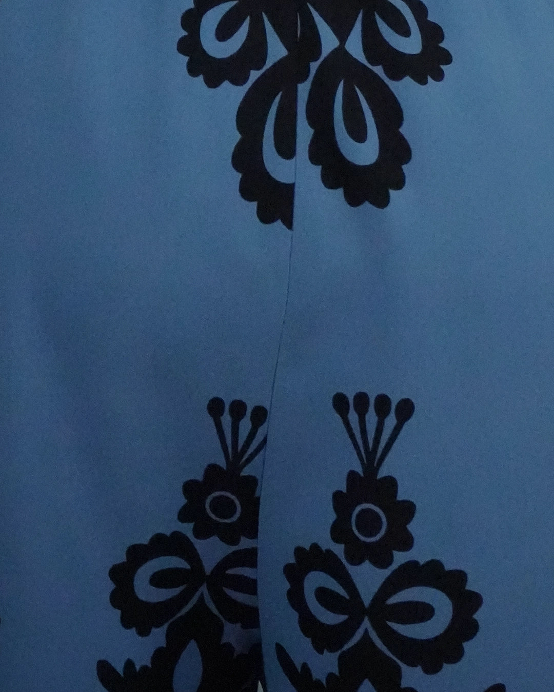 Black floral patterns on a blue background