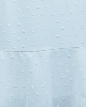 Close-up of light blue fabric with a subtle pattern