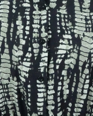 Close-up of a shirt with a black and white abstract pattern