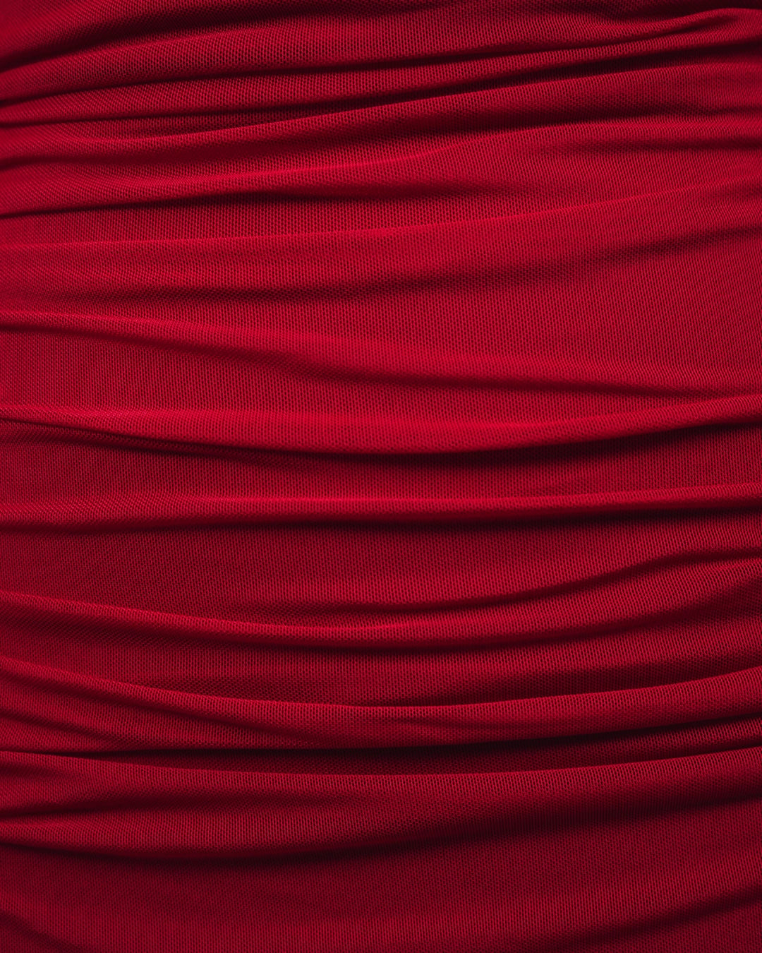 Close-up of red fabric with pleated texture