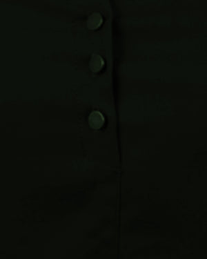 Close-up of a dark coat with button details on a black background