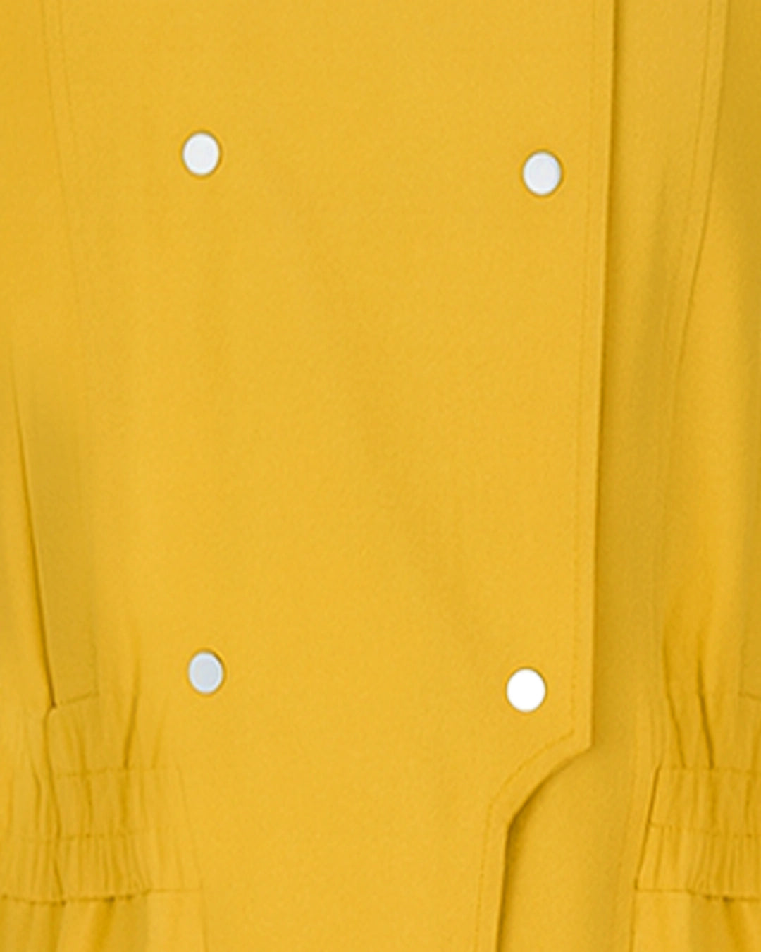 Close-up of a mustard yellow garment with white buttons.