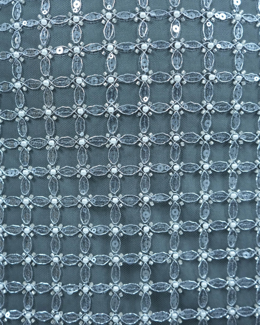 Close-up of a textured fabric with a lattice pattern on a blue background