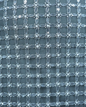 Close-up of a textured fabric with a lattice pattern on a blue background