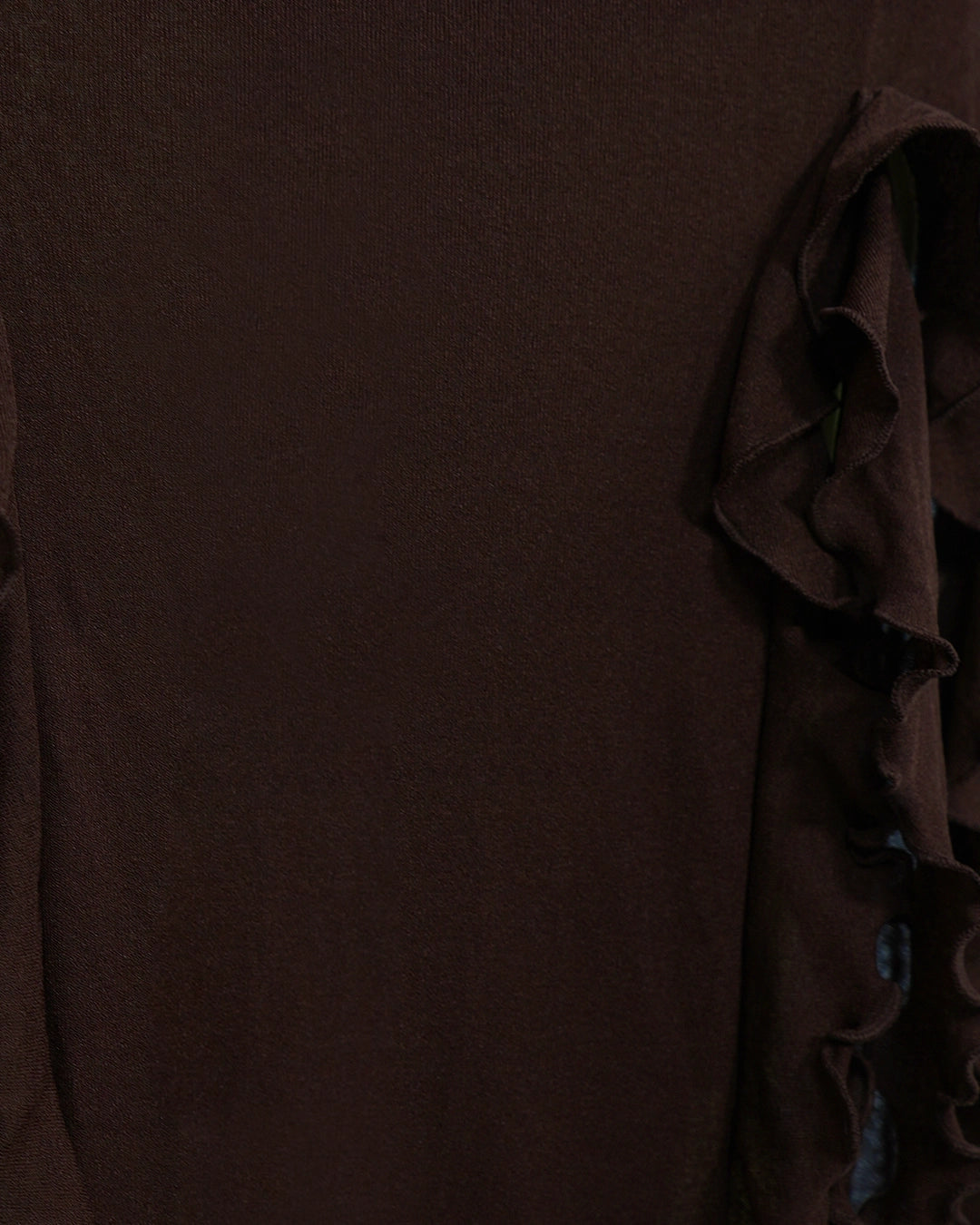 Brown fabric with ruffled edge on a plain background