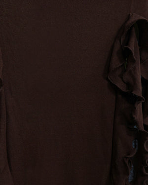 Brown fabric with ruffled edge on a plain background