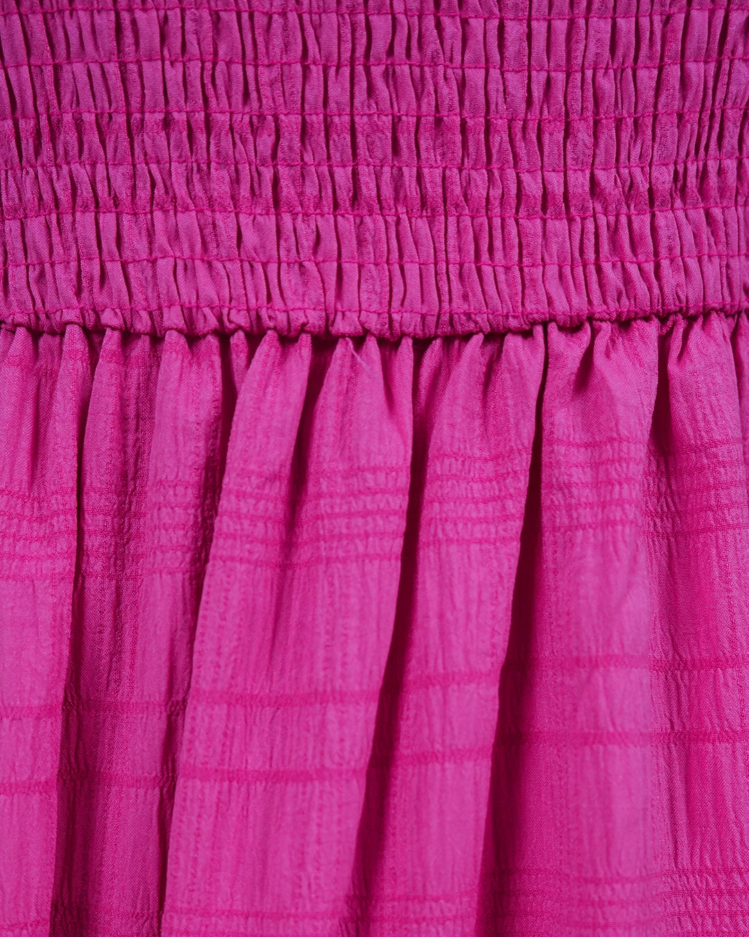 Close-up of a pink textured fabric dress