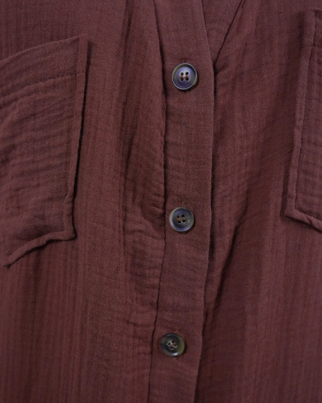 Close-up of a brown textured shirt with buttons