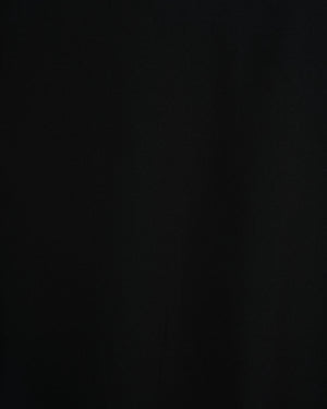 BeboNLolo black wrap dress close-up showing V-neckline and ruffle fabric detail – Close-Up View