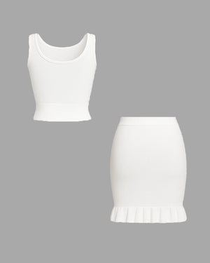 White tank top and skirt set on a gray background