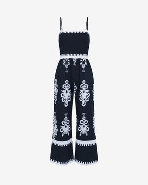 Navy blue jumpsuit with white embroidery on a white background