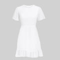White dress with ruffled hem on a gray background