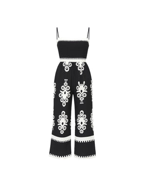 Black jumpsuit with white floral patterns on a white background