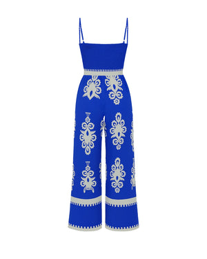 Blue jumpsuit with white patterns on a white background