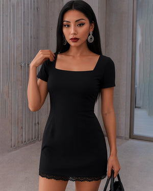 Woman wearing a black dress with a plain background