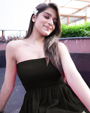 Woman wearing a black dress with a blurred background