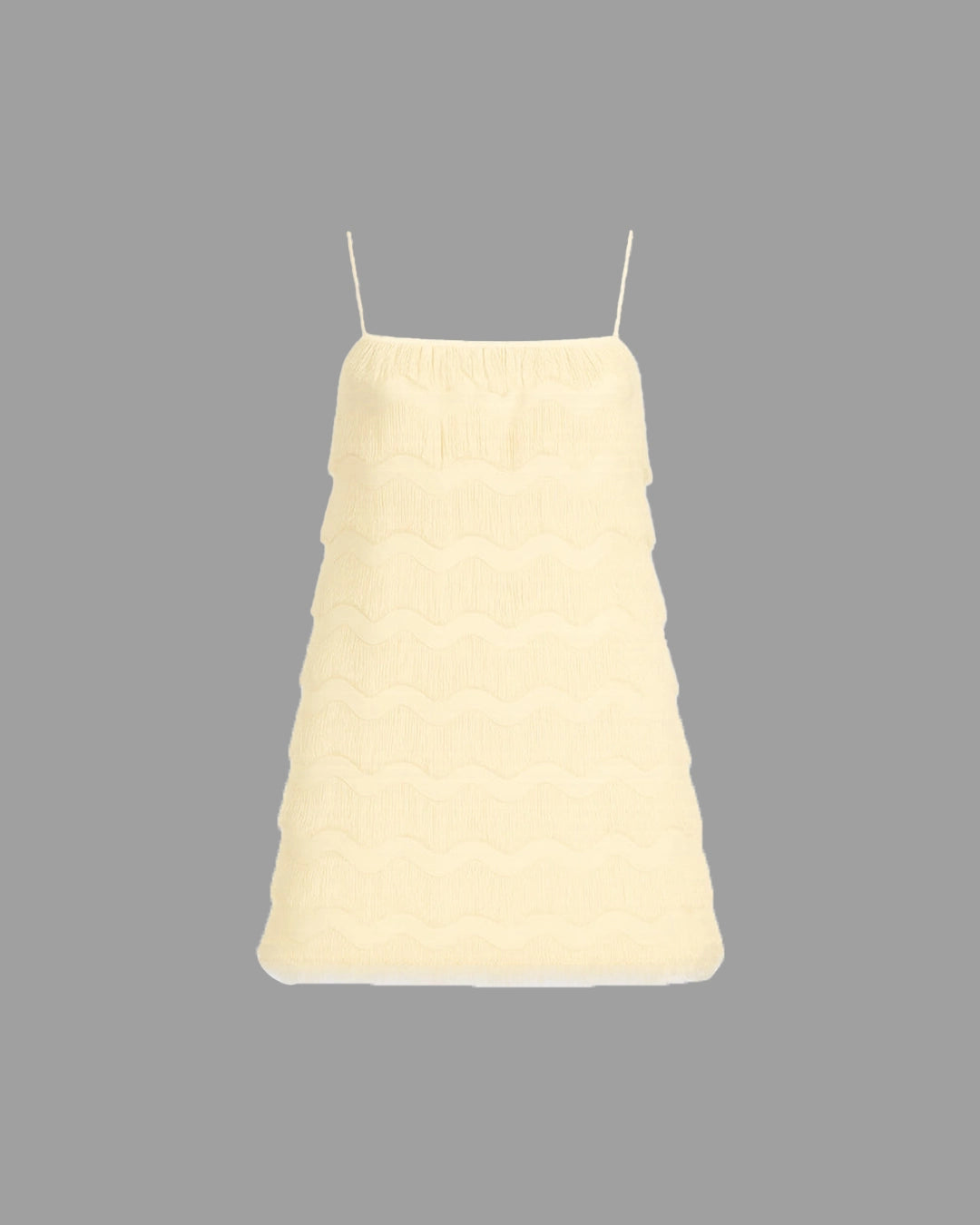 Light yellow dress with thin straps on a gray background