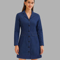 Woman wearing a blue coat against a gray background