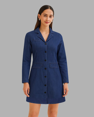 Woman wearing a blue coat against a gray background