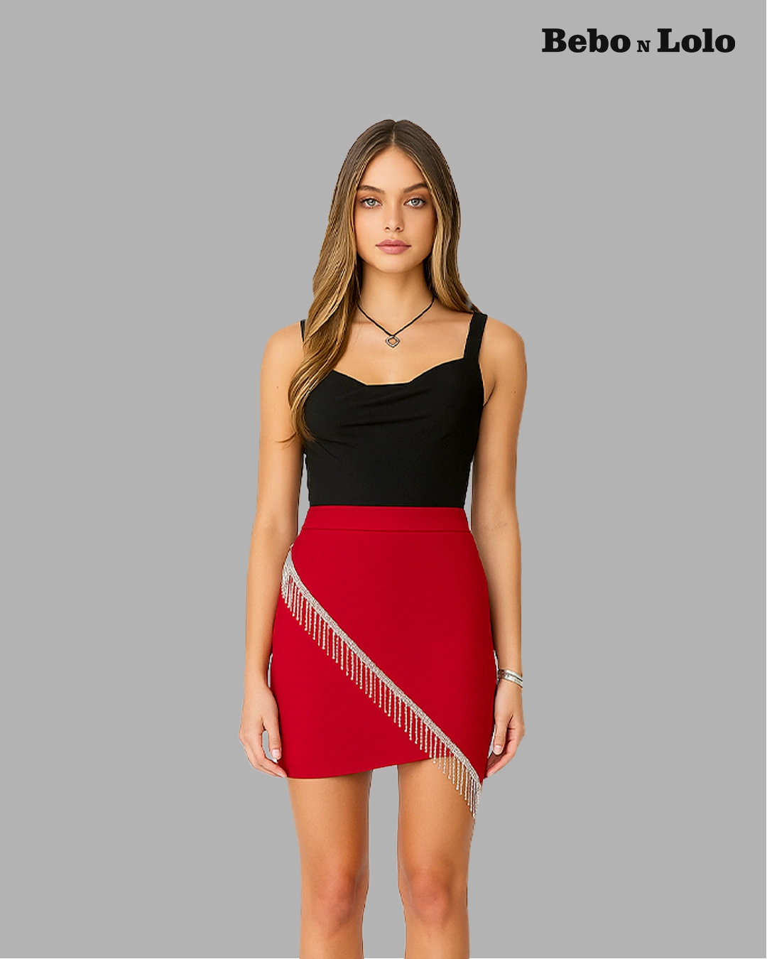 BeboNLolo red embellished mini skirt with silver fringe detail styled with black sleeveless top – Front View