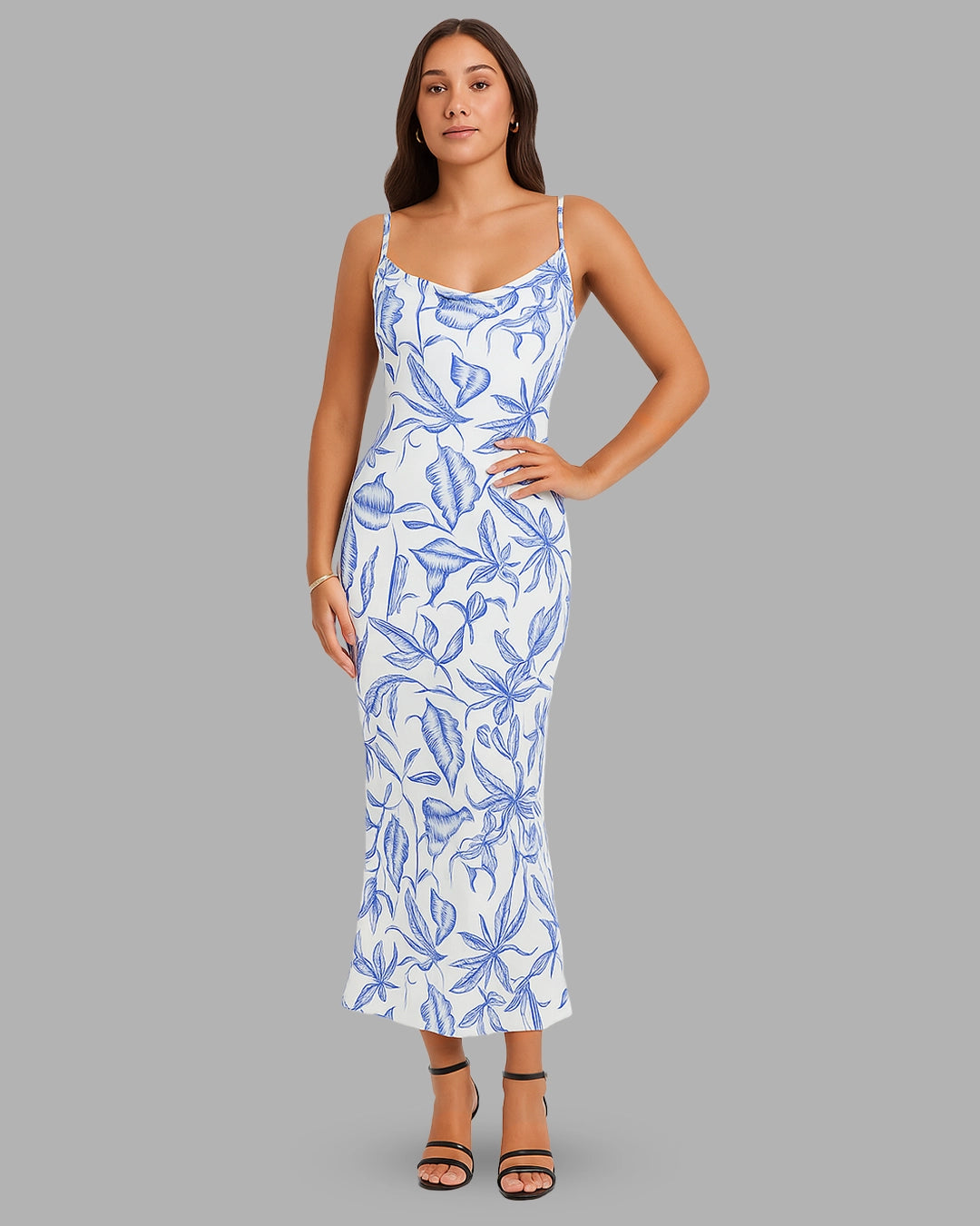 Woman wearing a blue floral dress on a gray background