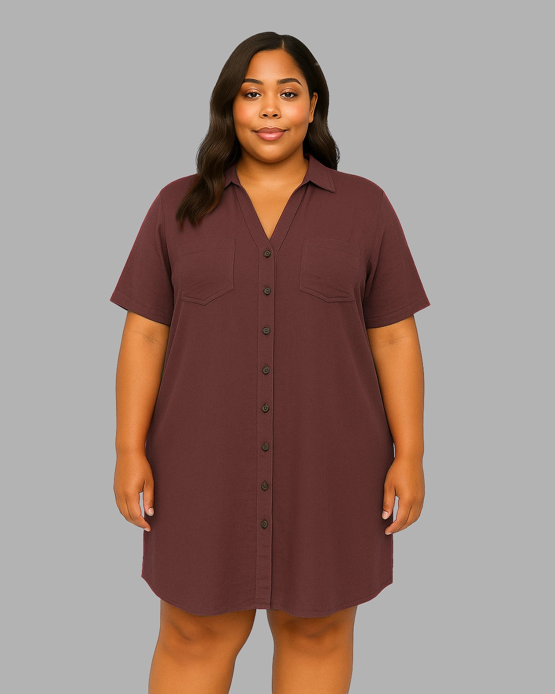 Woman wearing a brown button-up dress against a gray background