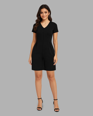 Woman wearing a black dress against a gray background