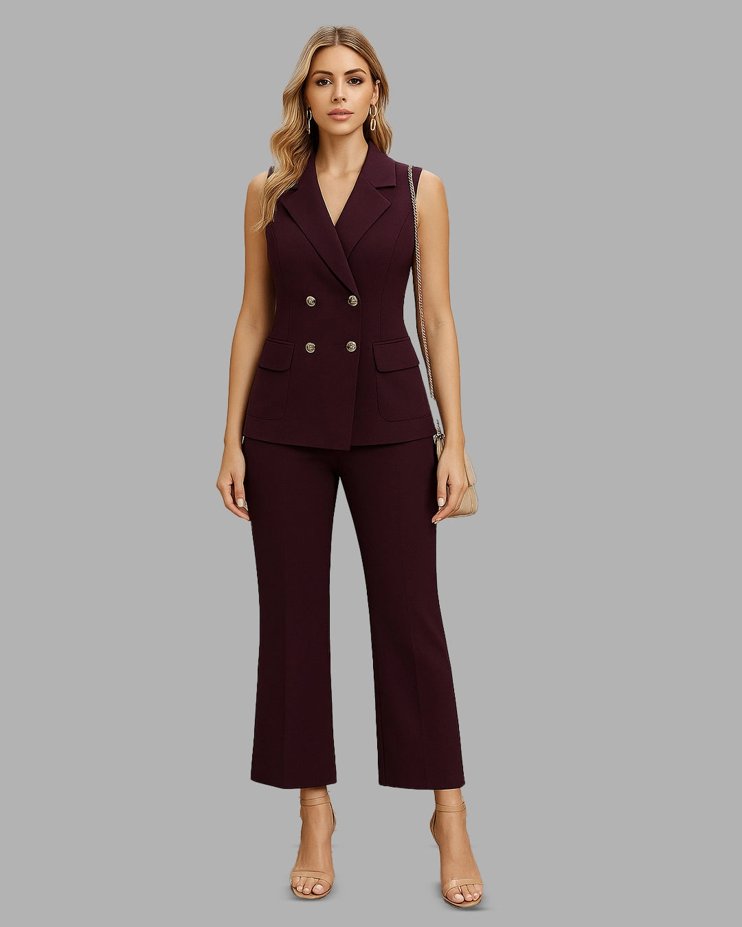 Woman wearing a burgundy suit on a gray background