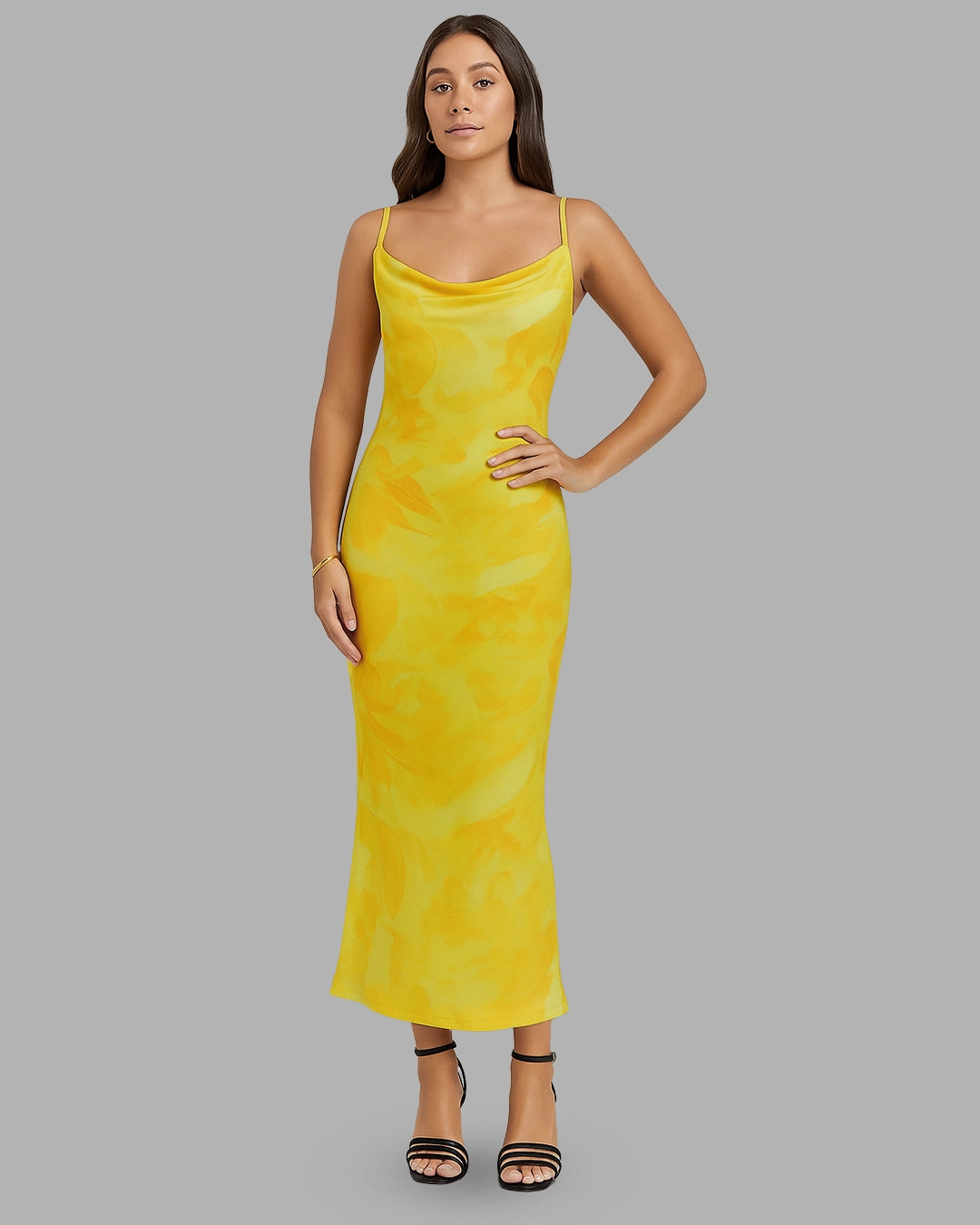 Woman wearing a yellow dress against a gray background