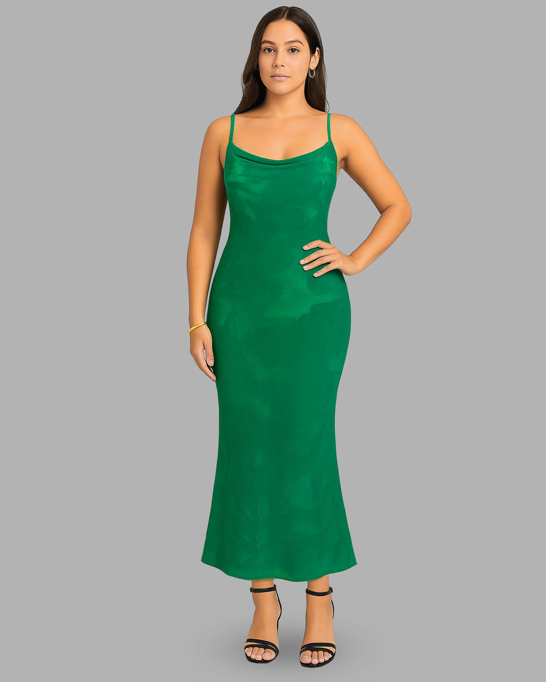 Woman wearing a green dress on a gray background