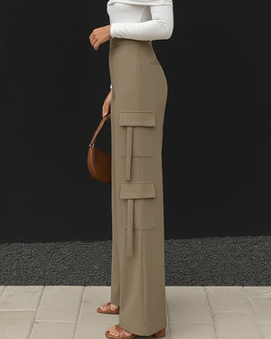Person wearing beige cargo pants with a black background