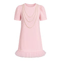 Pink dress with pearl necklace on a white background