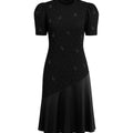 Black dress with puff sleeves and a pattern on a white background