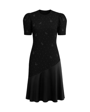 Black dress with puff sleeves and a pattern on a white background